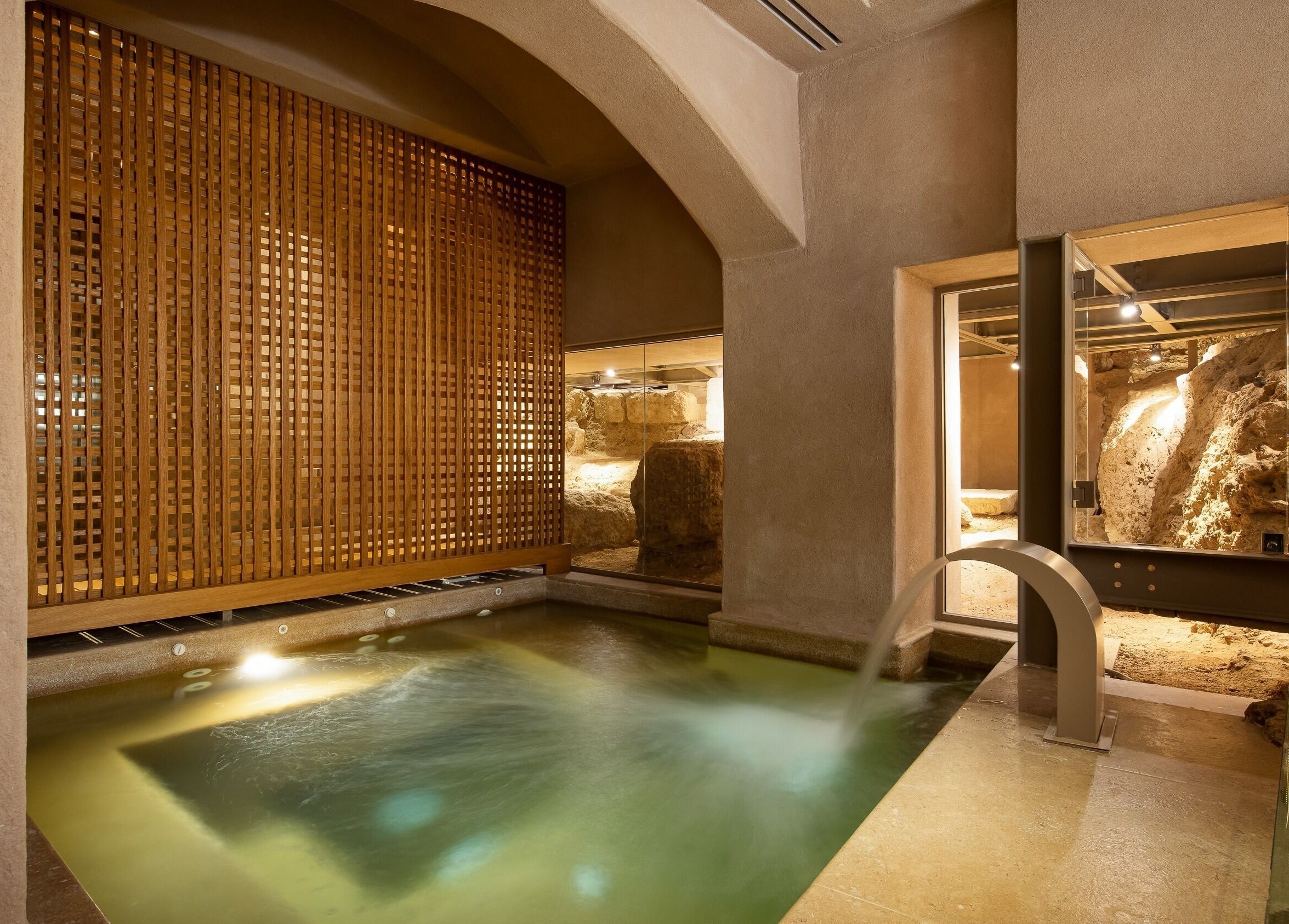Luxurious indoor spa pool with modern wooden accents at Niche Spa 300 B.C., Athina, GR.