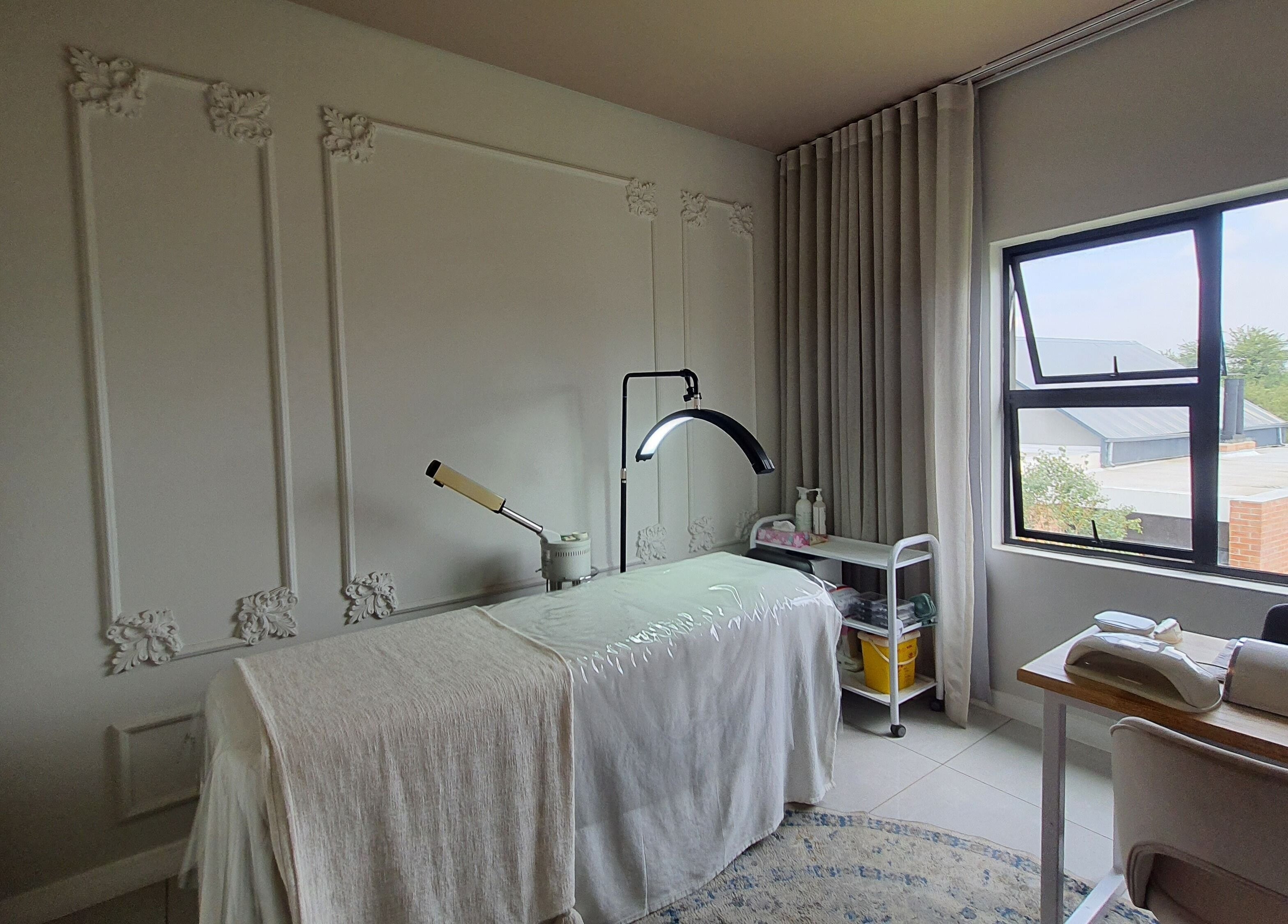 Serene treatment room at AesthetiDerm, Centurion, Gauteng, ZA with massage bed and natural light.