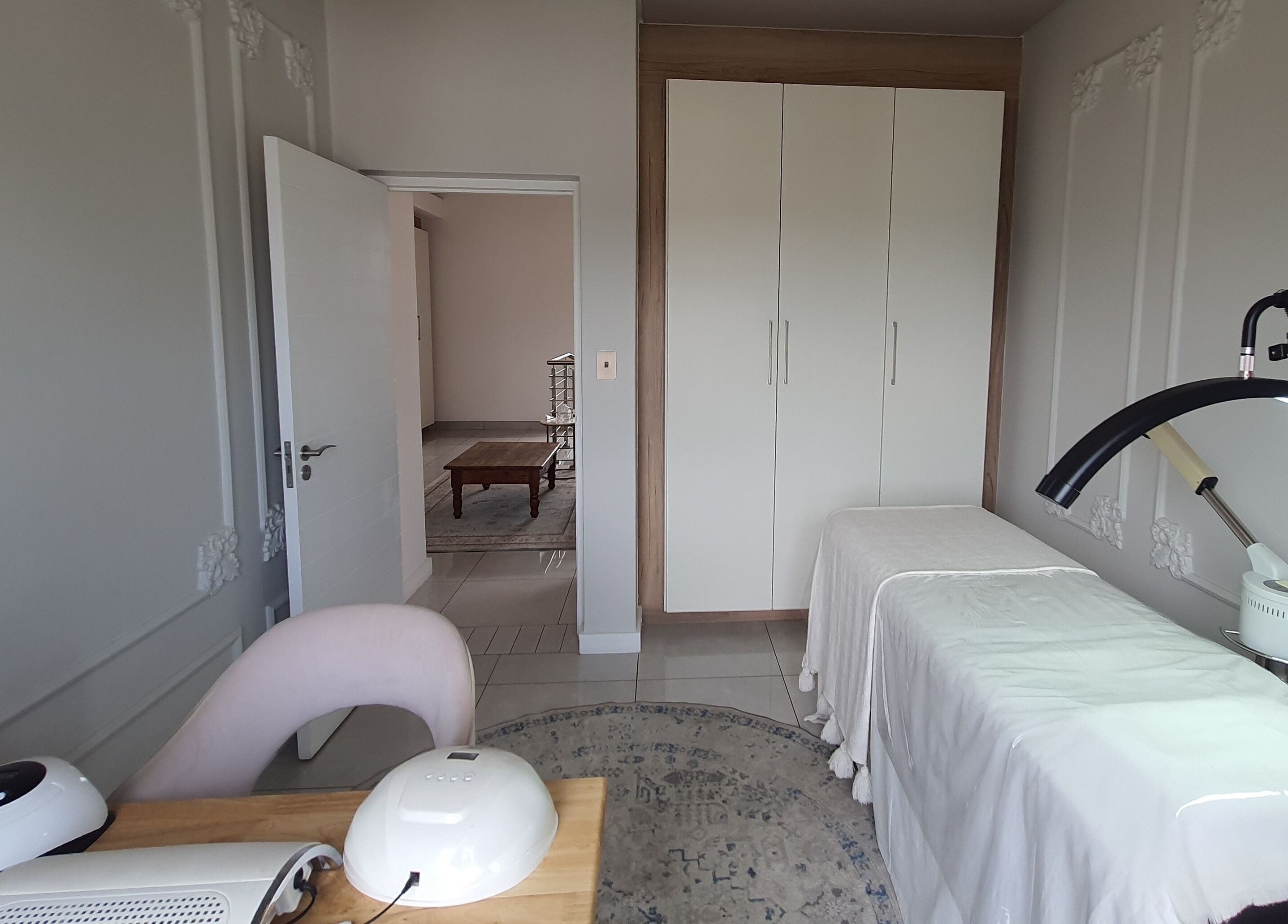 AesthetiDerm private treatment room in Centurion, Gauteng, ZA with massage table and elegant decor.