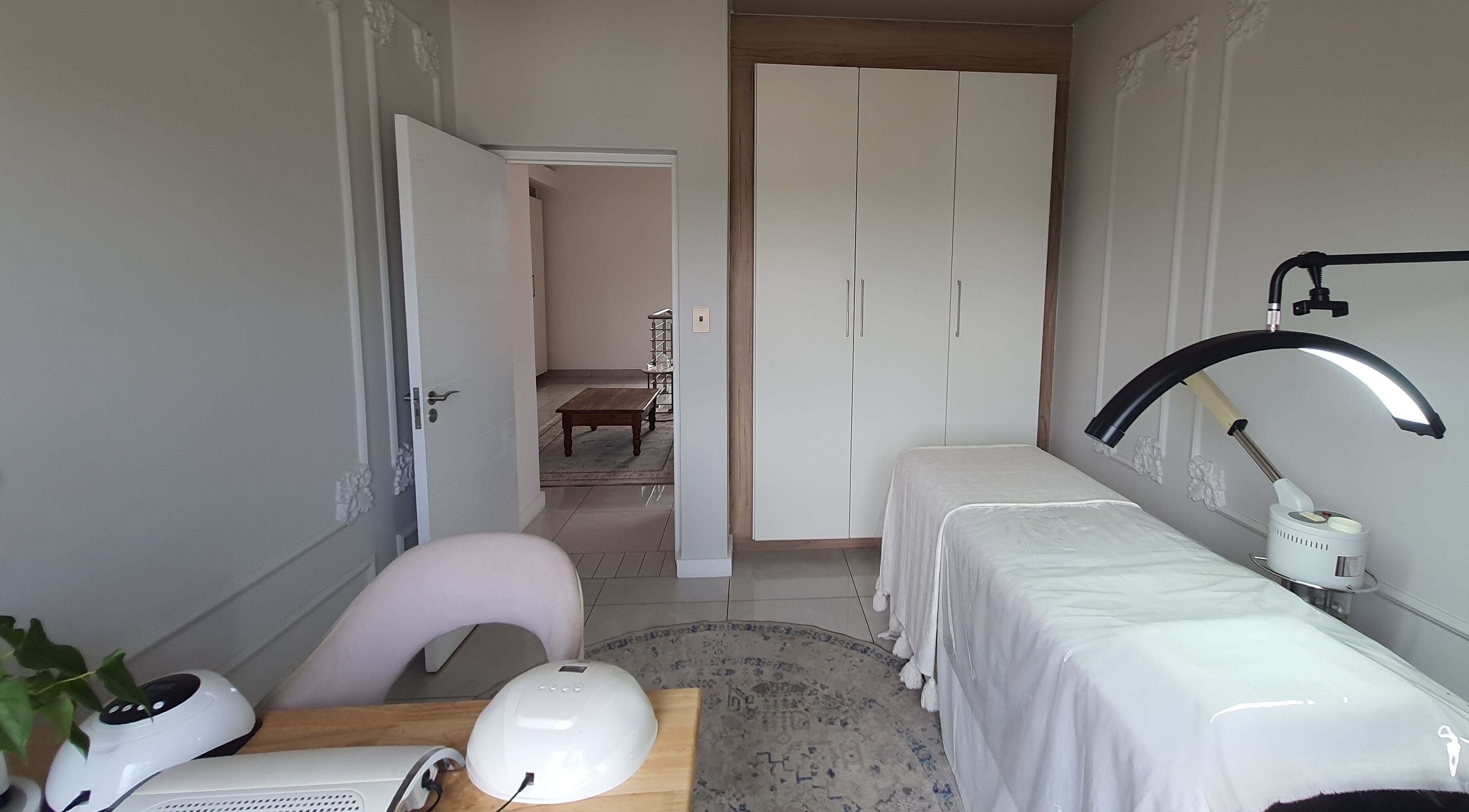 AesthetiDerm private treatment room in Centurion, Gauteng, ZA with massage table and elegant decor.