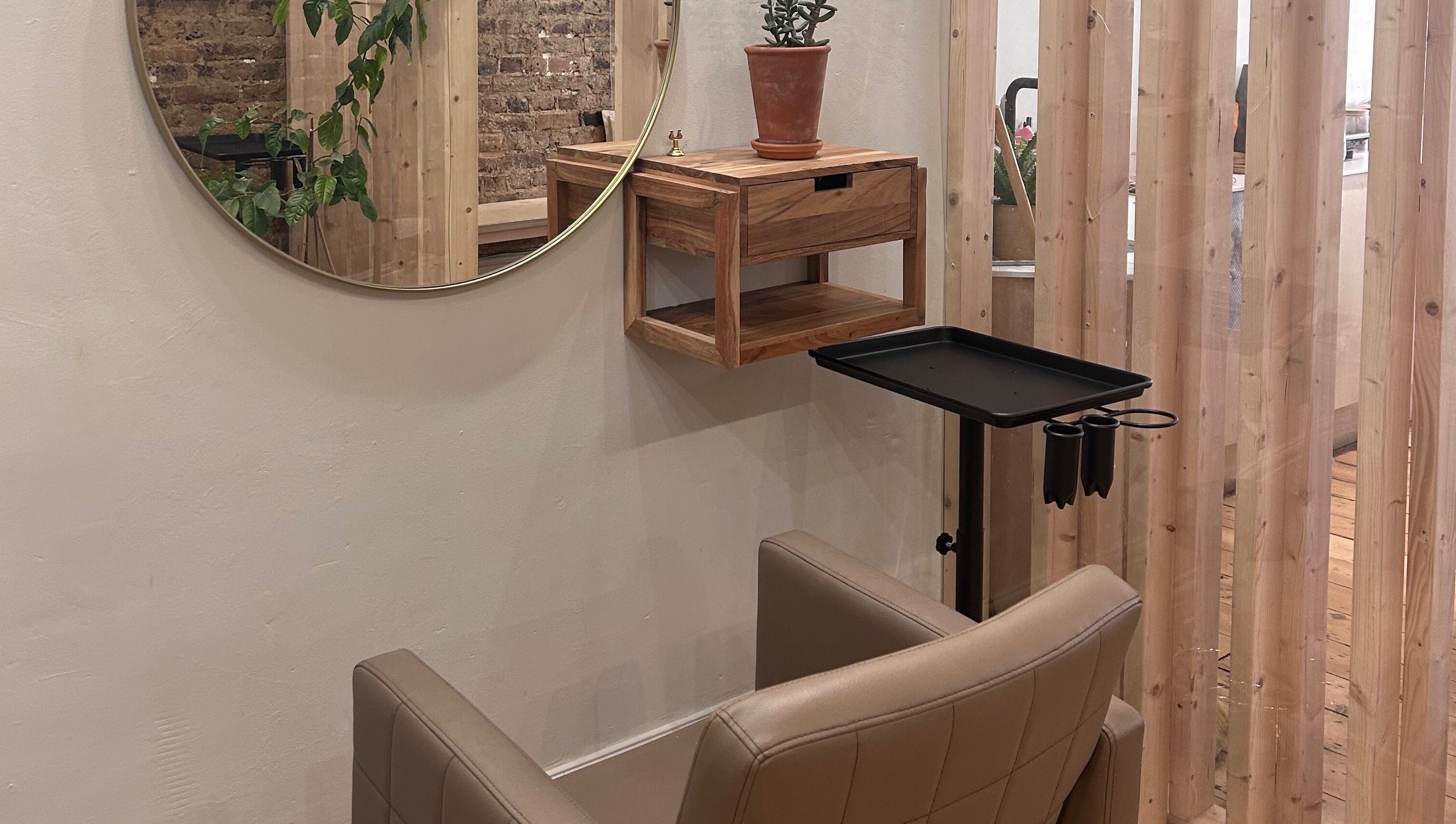 Stylish salon chair and round mirror at Claudia Cheesman Hair, Brighton And Hove, England, GB.