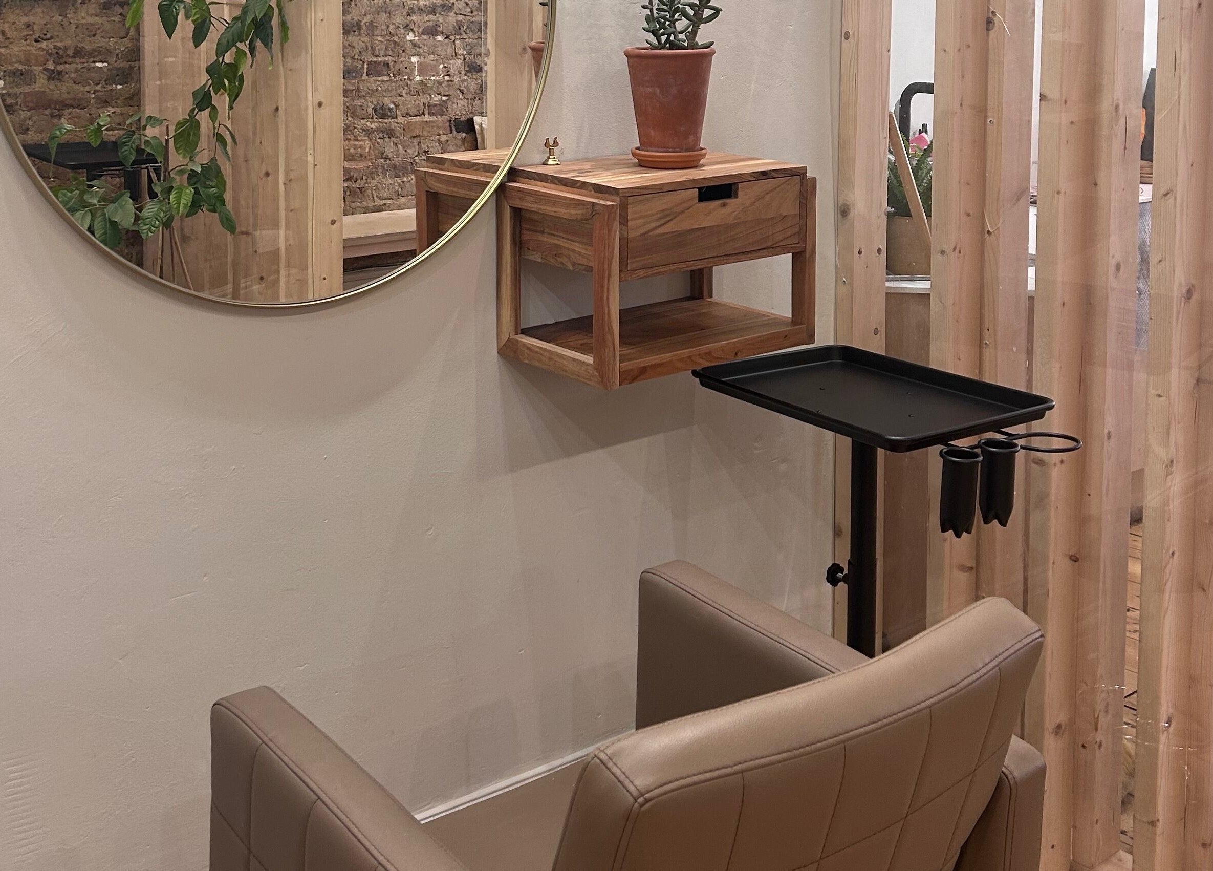 Stylish salon chair and round mirror at Claudia Cheesman Hair, Brighton And Hove, England, GB.