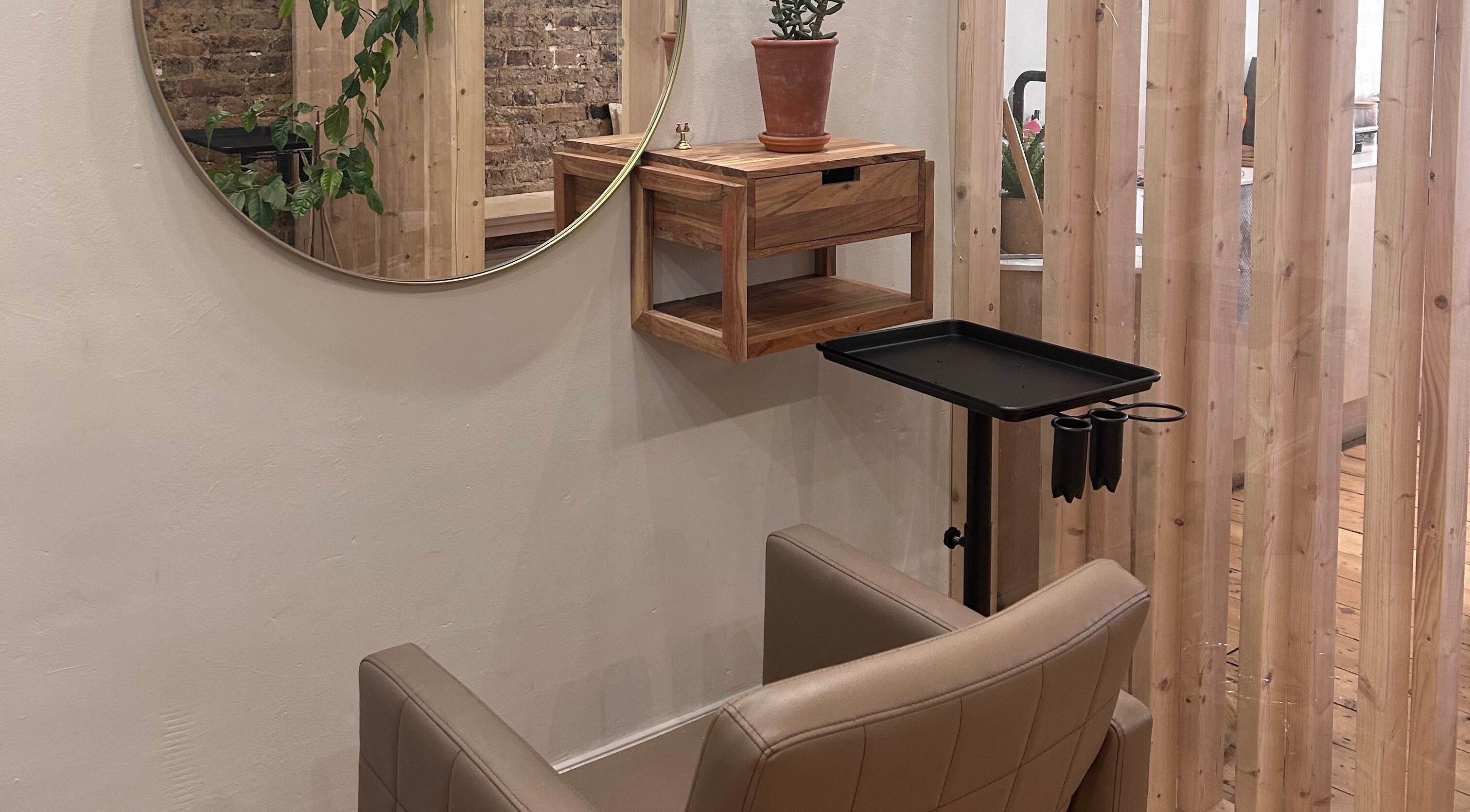 Stylish salon chair and round mirror at Claudia Cheesman Hair, Brighton And Hove, England, GB.