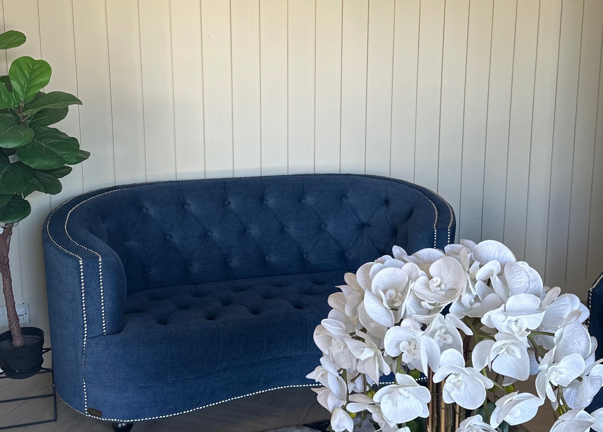 Elegant lounge at Spa Bekam Ar Rayyan Nilai, Bandar Baru Nilai, Negeri Sembilan, MY with blue sofa and white orchids.