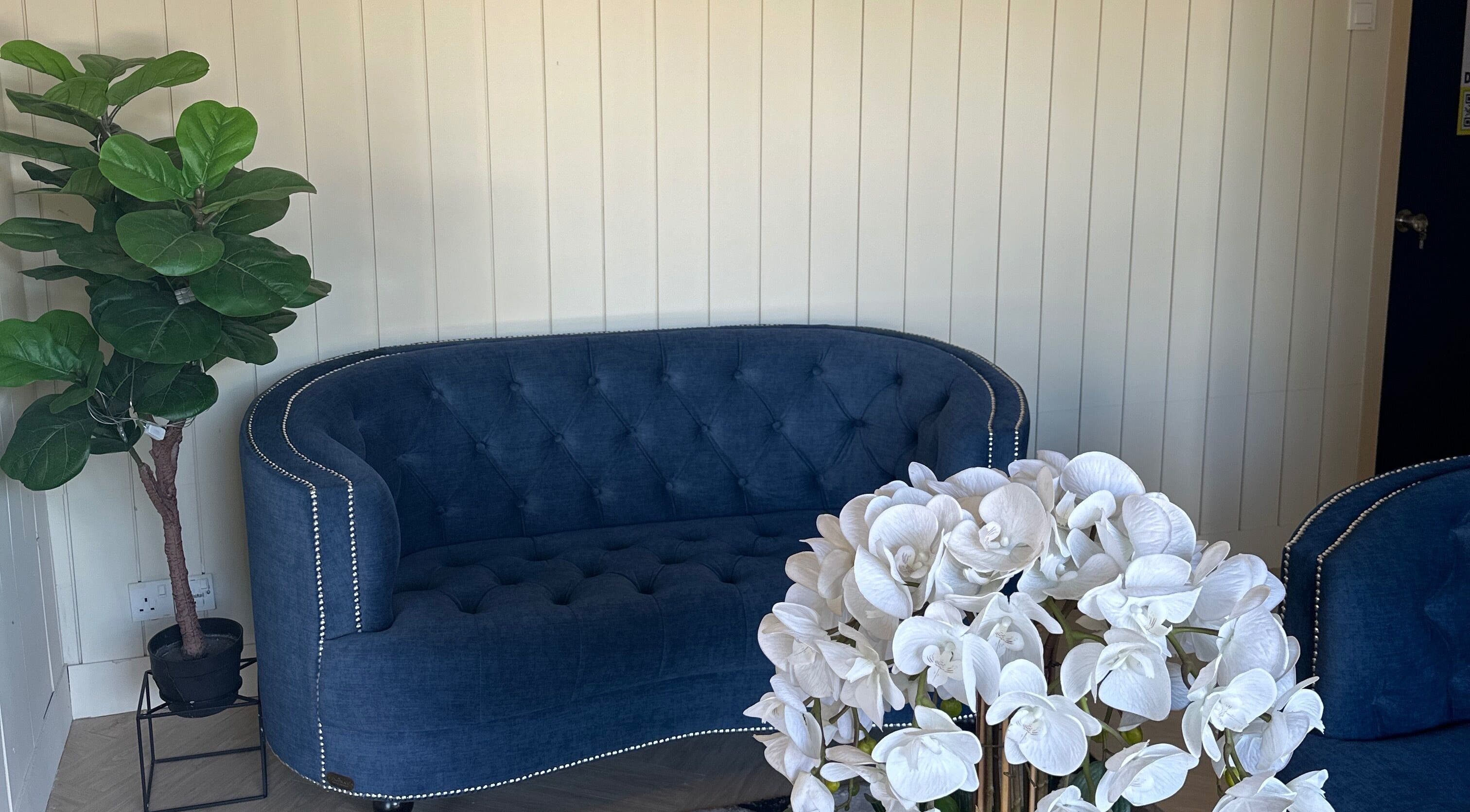 Elegant lounge at Spa Bekam Ar Rayyan Nilai, Bandar Baru Nilai, Negeri Sembilan, MY with blue sofa and white orchids.