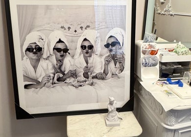 Framed picture of women in robes at Etonne Clinic, New York, New York, US, showcasing spa relaxation.