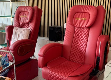 Deluxe red pedicure chairs at Nikki D Nails Beauty Aesthetics, Chadwell St Mary, England, GB.