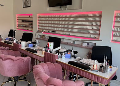 Elegant nail studio at Nikki D Nails Beauty Aesthetics, Chadwell St Mary, England, GB with plush pink chairs.