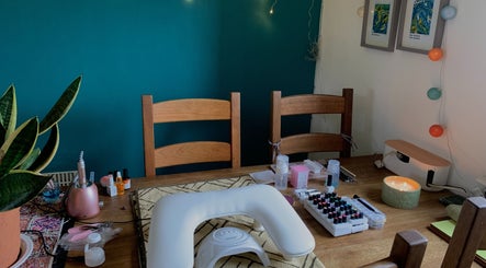 Nail care setup at Nails By Sohf, Manchester, England, GB featuring tools and vibrant polishes.