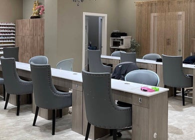Modern nail stations at 123 Nail Salon in Chicago, Illinois, US, featuring stylish gray chairs.