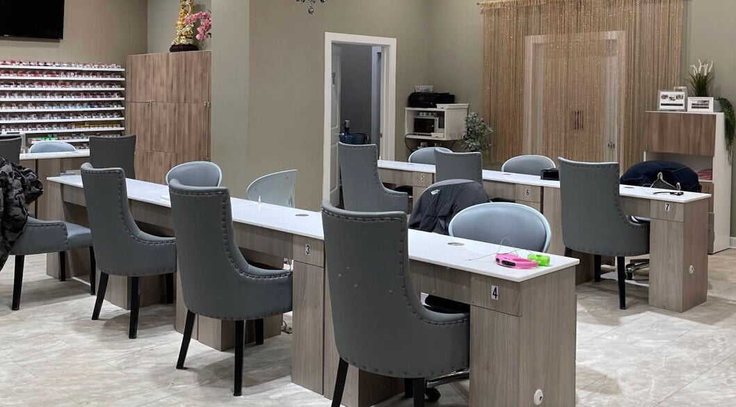 Modern nail stations at 123 Nail Salon in Chicago, Illinois, US, featuring stylish gray chairs.