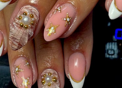 Intricate gold-accented nail art at Rachael Maria Artistry in Belfast, Northern Ireland, GB.