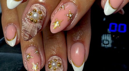 Intricate gold-accented nail art at Rachael Maria Artistry in Belfast, Northern Ireland, GB.