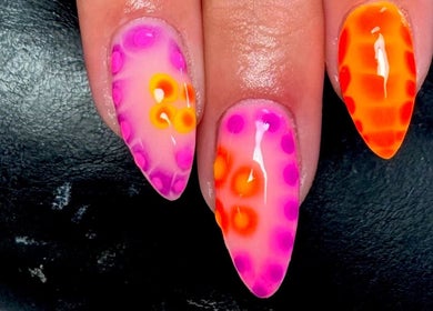 Vibrant nail art at Rachael Maria Artistry, Belfast, Northern Ireland, GB, featuring bright orange and pink designs.