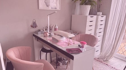Elegantly designed nail station at Aries Nails, Hitchin, England, GB, featuring soft pink chairs and modern decor.