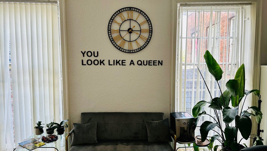Modern lounge at Victoria Concept Beauty Academy, Prescot, England, featuring green plants and a motivational quote.