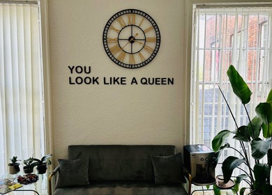 Modern lounge at Victoria Concept Beauty Academy, Prescot, England, featuring green plants and a motivational quote.