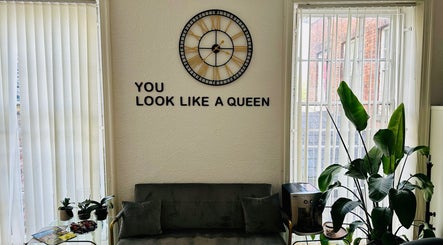 Modern lounge at Victoria Concept Beauty Academy, Prescot, England, featuring green plants and a motivational quote.