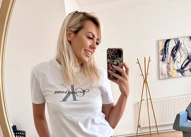 Woman in stylish salon at Victoria Concept Beauty Academy, Prescot, England, GB, capturing a selfie.