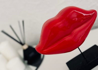 Red lip sculpture decor at Victoria Concept Beauty Academy in Prescot, England, GB.