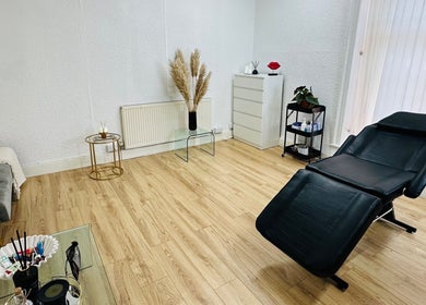 Elegant treatment room at Victoria Concept Beauty Academy, Prescot, England, GB with modern decor and a black chair.