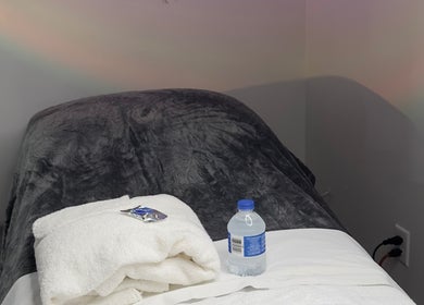 Relaxing treatment bed with towel and water at Elite Esthetics by Dalal, Lodi, California, US.