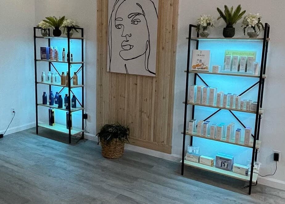 Product display at Elite Esthetics by Dalal in Lodi, California, US, featuring illuminated shelves and decor.