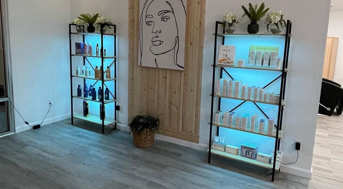 Product display at Elite Esthetics by Dalal in Lodi, California, US, featuring illuminated shelves and decor.