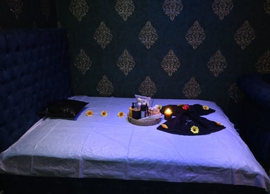 Relaxing spa room at Refresh D Thai Spa in Bengaluru, Karnataka, IN, featuring a cozy massage bed with ambient decor.