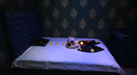 Relaxing spa room at Refresh D Thai Spa in Bengaluru, Karnataka, IN, featuring a cozy massage bed with ambient decor.