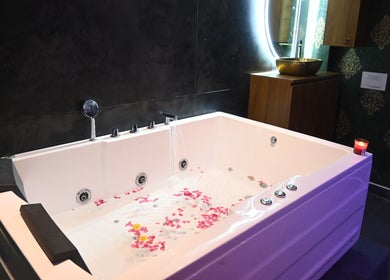 Luxurious spa bath with petals at Refresh D Thai Spa, Bengaluru, Karnataka, IN.