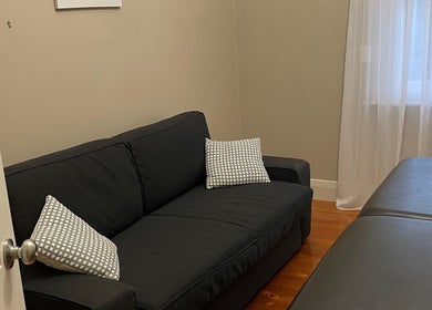 A cozy therapy room in My Circle of Wellness, Mount Gambier, South Australia, AU with a couch and massage table.