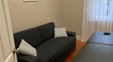 A cozy therapy room in My Circle of Wellness, Mount Gambier, South Australia, AU with a couch and massage table.