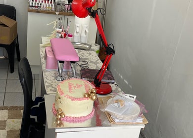 Comfortable workspace at Nailed By Ndasi in Gqeberha, Eastern Cape, ZA, featuring a decorated cake.