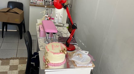 Comfortable workspace at Nailed By Ndasi in Gqeberha, Eastern Cape, ZA, featuring a decorated cake.