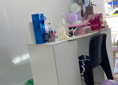 Modern nail station at Nailed By Ndasi in Gqeberha, Eastern Cape, ZA with decor and manicure tools.