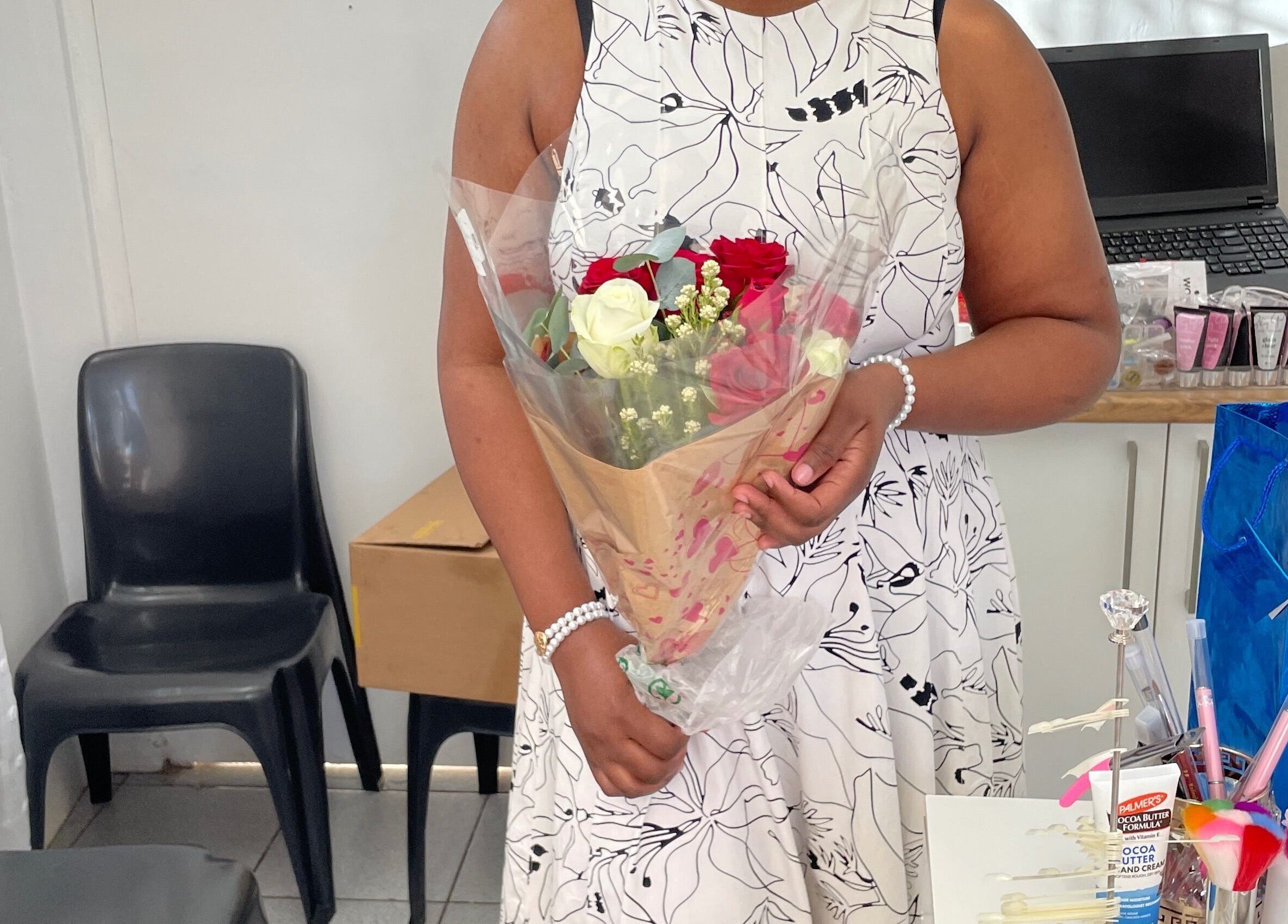 Client holding flowers in Nailed By Ndasi, Gqeberha, Eastern Cape, ZA beauty studio.