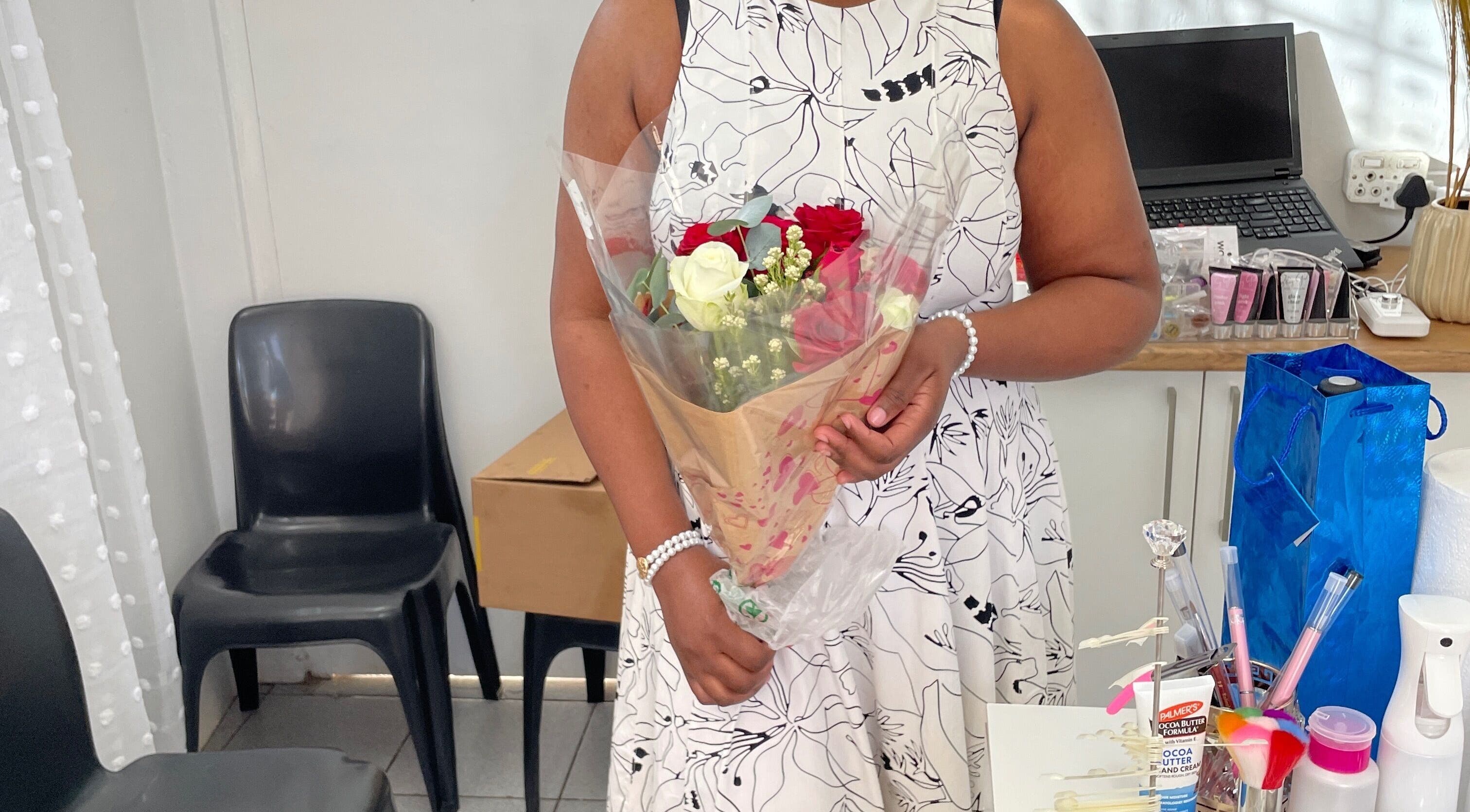 Client holding flowers in Nailed By Ndasi, Gqeberha, Eastern Cape, ZA beauty studio.