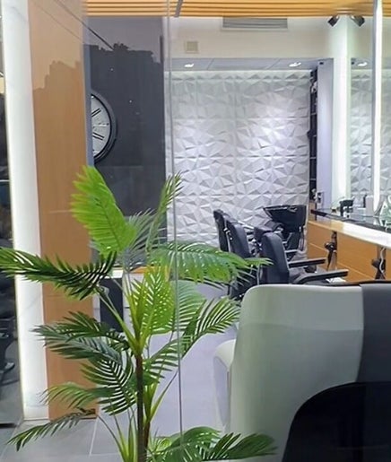 Modern interior of Tahan Barbershop in Beirut, Beirut Governorate, LB showcasing sleek chairs and elegant decor.
