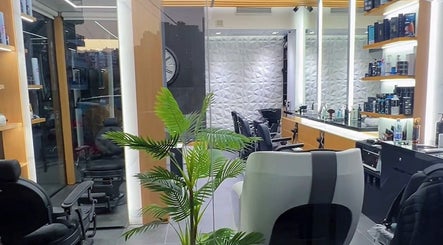 Modern interior of Tahan Barbershop in Beirut, Beirut Governorate, LB showcasing sleek chairs and elegant decor.