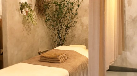 Tranquil massage room at Kea Forest, Korora, New South Wales, AU with inviting decor and plush towels.