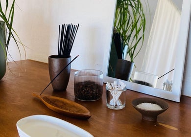 Tranquil spa setup at Kea Forest, Korora, New South Wales, AU with incense, plants, and mirror.