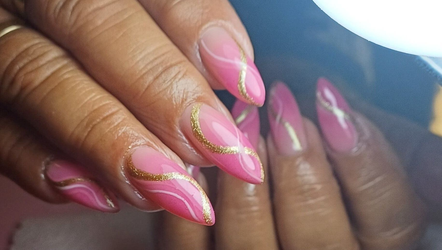Pink nails with gold accents at Tee&Co., Cape Town, Western Cape, ZA showcasing elegant nail art.