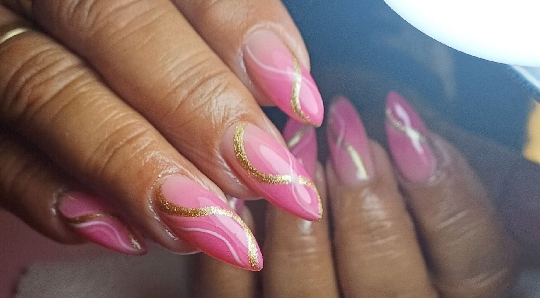 Pink nails with gold accents at Tee&Co., Cape Town, Western Cape, ZA showcasing elegant nail art.