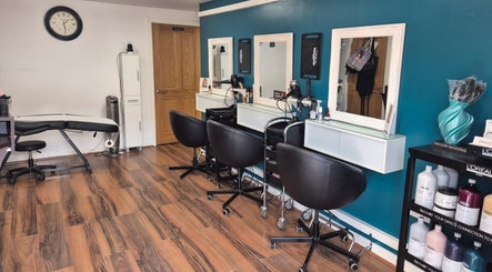 Modern styling chairs and mirrors at Hair Flair, Sheffield, England, GB with wooden flooring.