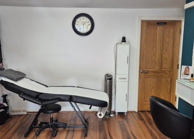 Cozy salon interior at Hair Flair, Sheffield, England, GB, featuring a comfortable treatment bed and elegant decor.