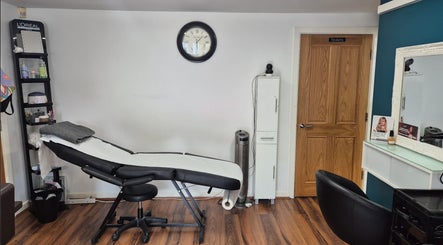 Cozy salon interior at Hair Flair, Sheffield, England, GB, featuring a comfortable treatment bed and elegant decor.