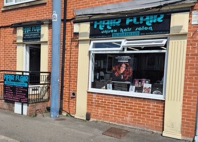 Exterior of Hair Flair, a beauty salon in Sheffield, England, GB, showcasing its stylish brick facade.