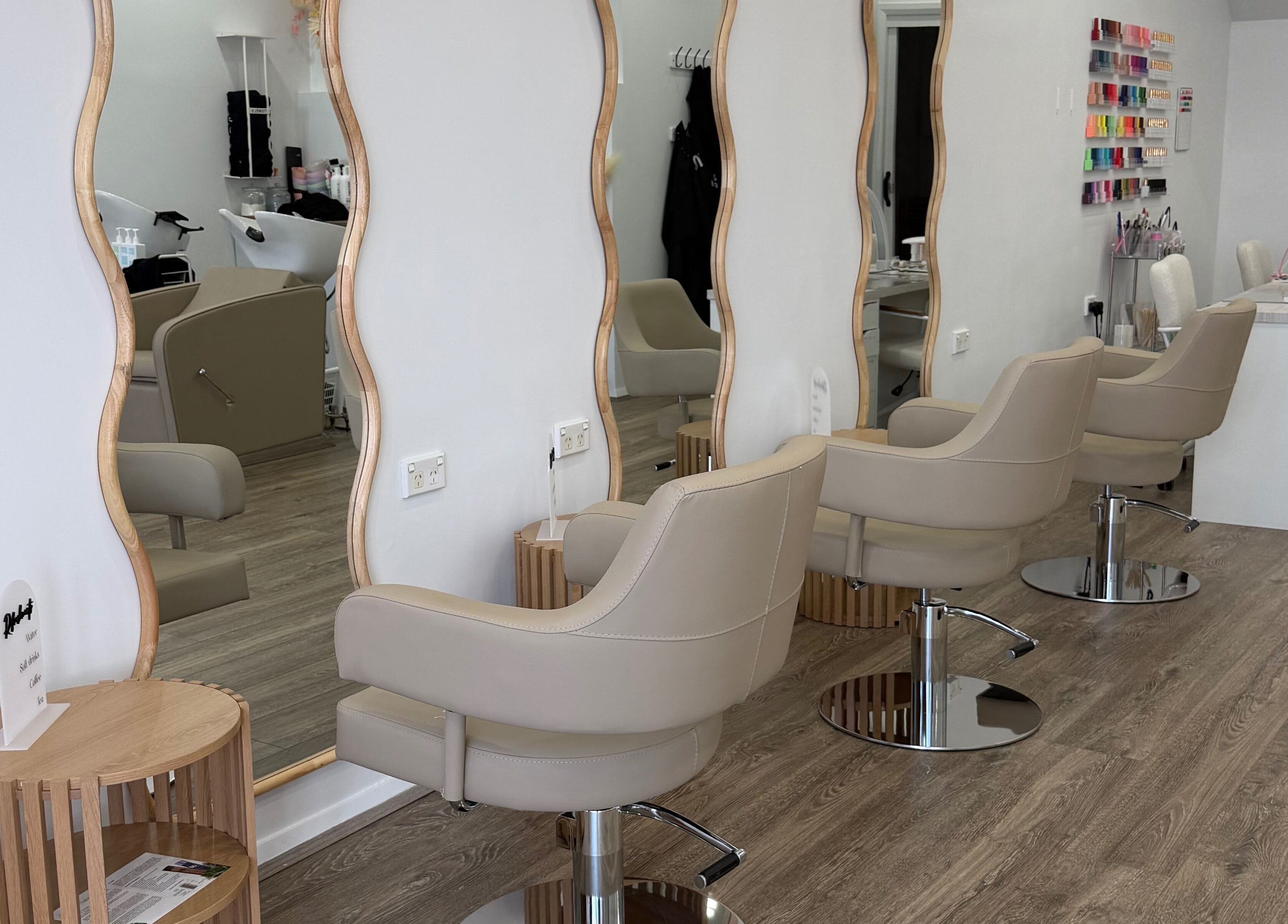 Chic salon interior with stylish chairs at Heavenly Strands, Glen Alpine, New South Wales, AU.
