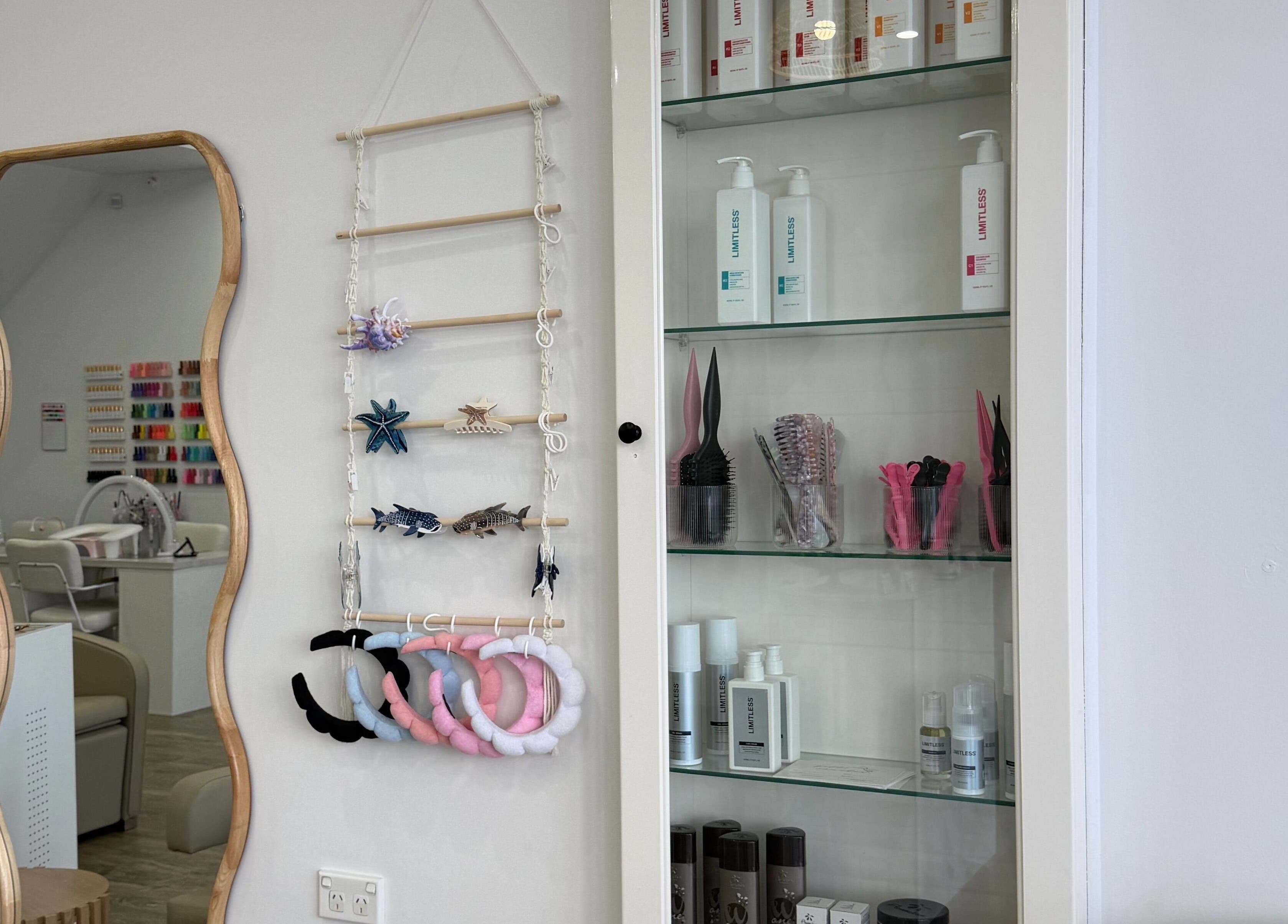 Chic salon interior with mirror and hair products at Heavenly Strands, Glen Alpine, New South Wales, AU.